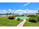 Well-manicured putting green surrounded by lush landscaping and offering beautiful water views at 4380 Exeter Dr # 204, Longboat Key, FL 34228