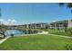 Scenic view of condos overlooking lush green lawns and a tranquil waterfront with boat docks at 4380 Exeter Dr # 204, Longboat Key, FL 34228