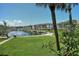 Scenic view of condos overlooking lush green lawns and a tranquil waterfront with boat docks at 4380 Exeter Dr # 204, Longboat Key, FL 34228