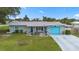 Charming single-story home with a well-manicured lawn, a bright blue garage door, and inviting front patio at 453 Sandlewood Dr, Venice, FL 34293