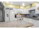 Bright kitchen with white cabinetry, granite countertops, tile backsplash, and stainless steel appliances at 453 Sandlewood Dr, Venice, FL 34293