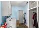 Practical laundry room features ample storage cabinets, washer, dryer, and easy backyard access at 453 Sandlewood Dr, Venice, FL 34293