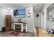 Cozy living room features a fireplace, mounted TV, decor lizards and access to other rooms at 453 Sandlewood Dr, Venice, FL 34293