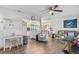 Spacious living room with wood floors, open kitchen view, comfortable seating, and stylish decorations at 453 Sandlewood Dr, Venice, FL 34293