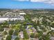 Beautiful aerial view of a landscaped property with mature trees surrounded by retail and neighborhood at 4805 Cypress Lake Ct, Sarasota, FL 34243