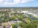 A beautiful single Gathering home as seen from above with mature trees and well manicured lawn at 4805 Cypress Lake Ct, Sarasota, FL 34243