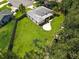 An aerial view of the property showing a spacious backyard, mature trees, and a well-maintained lawn at 4805 Cypress Lake Ct, Sarasota, FL 34243