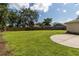 A large, fenced backyard offering ample space, lush greenery, and privacy for outdoor activities and relaxation at 4805 Cypress Lake Ct, Sarasota, FL 34243