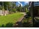 A spacious backyard with a well-kept lawn, a concrete patio, and lush trees enhancing the outdoor appeal at 4805 Cypress Lake Ct, Sarasota, FL 34243