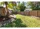 A fenced backyard showcasing a well-maintained lawn, offering privacy and a safe space for outdoor enjoyment at 4805 Cypress Lake Ct, Sarasota, FL 34243