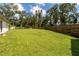 A vast, green backyard enclosed by a wooden fence, providing a private and spacious outdoor area at 4805 Cypress Lake Ct, Sarasota, FL 34243