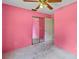 Bright pink bedroom features carpeting, a ceiling fan, and both sliding mirror closet and a standard door at 4805 Cypress Lake Ct, Sarasota, FL 34243
