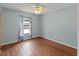 Bright bedroom with hardwood flooring, ceiling fan and a window offering great natural light at 4805 Cypress Lake Ct, Sarasota, FL 34243