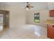 Bright dining area with tile flooring, a ceiling fan, and a view to the outdoors through a window at 4805 Cypress Lake Ct, Sarasota, FL 34243