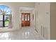 Inviting foyer featuring tiled floors, natural light from a window, and a closet for added storage at 4805 Cypress Lake Ct, Sarasota, FL 34243