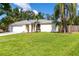 Charming one-story home with a well-manicured lawn and mature trees, enhancing its curb appeal at 4805 Cypress Lake Ct, Sarasota, FL 34243