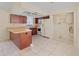 Bright kitchen featuring an island, stainless appliances, and a view of the laundry area at 4805 Cypress Lake Ct, Sarasota, FL 34243