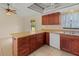 Well-lit kitchen with ample cabinet space, stainless appliances, and a breakfast bar at 4805 Cypress Lake Ct, Sarasota, FL 34243