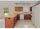Bright kitchen with stainless steel appliances, light countertops, and dark cabinetry at 4805 Cypress Lake Ct, Sarasota, FL 34243