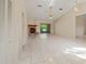 Expansive living room with tile flooring, a cozy fireplace, and sliding glass doors to the outdoor area at 4805 Cypress Lake Ct, Sarasota, FL 34243
