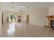 Open-concept living space with tile floors, a stone fireplace, and ample natural light, perfect for relaxing at 4805 Cypress Lake Ct, Sarasota, FL 34243
