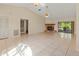 Bright living room boasts tile floors, a cozy fireplace, and access to a screened patio, ideal for entertaining at 4805 Cypress Lake Ct, Sarasota, FL 34243