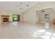 Spacious living room featuring tile floors, a fireplace, and access to the screened patio, perfect for gatherings at 4805 Cypress Lake Ct, Sarasota, FL 34243