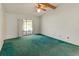 Main bedroom with vaulted ceiling, ceiling fan, and sliding glass door access to the backyard at 4805 Cypress Lake Ct, Sarasota, FL 34243