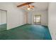 Bright main bedroom with vaulted ceilings, ceiling fan, and sliding door access to a patio at 4805 Cypress Lake Ct, Sarasota, FL 34243