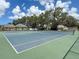 Well maintained tennis courts in a quiet neighborhood setting on a sunny day at 4805 Cypress Lake Ct, Sarasota, FL 34243