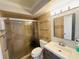 Well-lit bathroom featuring glass shelving, a shower, and a sleek vanity with a modern sink at 4805 Rilma Ave # 106, Sarasota, FL 34234