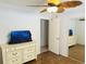 Bright bedroom featuring a mirrored closet, stylish dresser, and ceiling fan for added comfort at 4805 Rilma Ave # 106, Sarasota, FL 34234