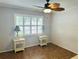 Cozy bedroom with a decorative ceiling fan, shuttered windows, and matching nightstands at 4805 Rilma Ave # 106, Sarasota, FL 34234