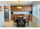 Inviting dining area with a stylish light fixture, a decorative window, and built-in wooden cabinets at 4805 Rilma Ave # 106, Sarasota, FL 34234
