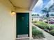 Image of front door with unit number, complemented by a well-manicured walkway and lush landscaping at 4805 Rilma Ave # 106, Sarasota, FL 34234