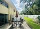 Private brick-paved patio with an outdoor dining set and white vinyl privacy fence at 4805 Rilma Ave # 106, Sarasota, FL 34234