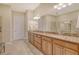 Large bathroom vanity has double sinks, light-colored walls and floors, and plenty of storage space at 4916 Tivoli Run, Bradenton, FL 34211