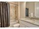 Neutral toned bathroom with tile surround tub and shower, granite countertops and integrated sink at 4916 Tivoli Run, Bradenton, FL 34211