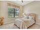 Cozy bedroom with neutral tones and lots of natural light from the window overlooking the yard at 4916 Tivoli Run, Bradenton, FL 34211