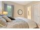 Bedroom featuring a decorative mirror, neutral tones, and lots of natural light at 4916 Tivoli Run, Bradenton, FL 34211