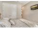Bedroom with a wall-mounted television and a view of the double doors and hallway at 4916 Tivoli Run, Bradenton, FL 34211