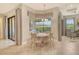 Bright breakfast nook with large windows and a sliding door to the outdoor area at 4916 Tivoli Run, Bradenton, FL 34211