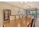 Open concept dining room featuring an expansive view of the living area and sliding glass doors to the patio at 4916 Tivoli Run, Bradenton, FL 34211