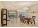 Spacious dining room area showcasing an open floor plan, modern chandelier, and sliding glass doors at 4916 Tivoli Run, Bradenton, FL 34211