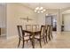 Traditional dining room features a wooden table with seating for six and elegant lighting at 4916 Tivoli Run, Bradenton, FL 34211