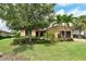 Beautiful single Gathering home featuring a tile roof, brick driveway, and lush landscaping with palm trees at 4916 Tivoli Run, Bradenton, FL 34211