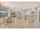 A great room with kitchen, living and dining areas is brightly illuminated with recessed lighting at 4916 Tivoli Run, Bradenton, FL 34211