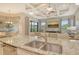 Granite counters and stainless steel sink complement the tray ceiling and bright, open floorplan at 4916 Tivoli Run, Bradenton, FL 34211