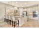 Bright kitchen featuring a large island with barstool seating and stainless steel appliances at 4916 Tivoli Run, Bradenton, FL 34211