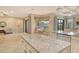 Open kitchen view with large island, stainless steel appliances, and connecting living spaces at 4916 Tivoli Run, Bradenton, FL 34211